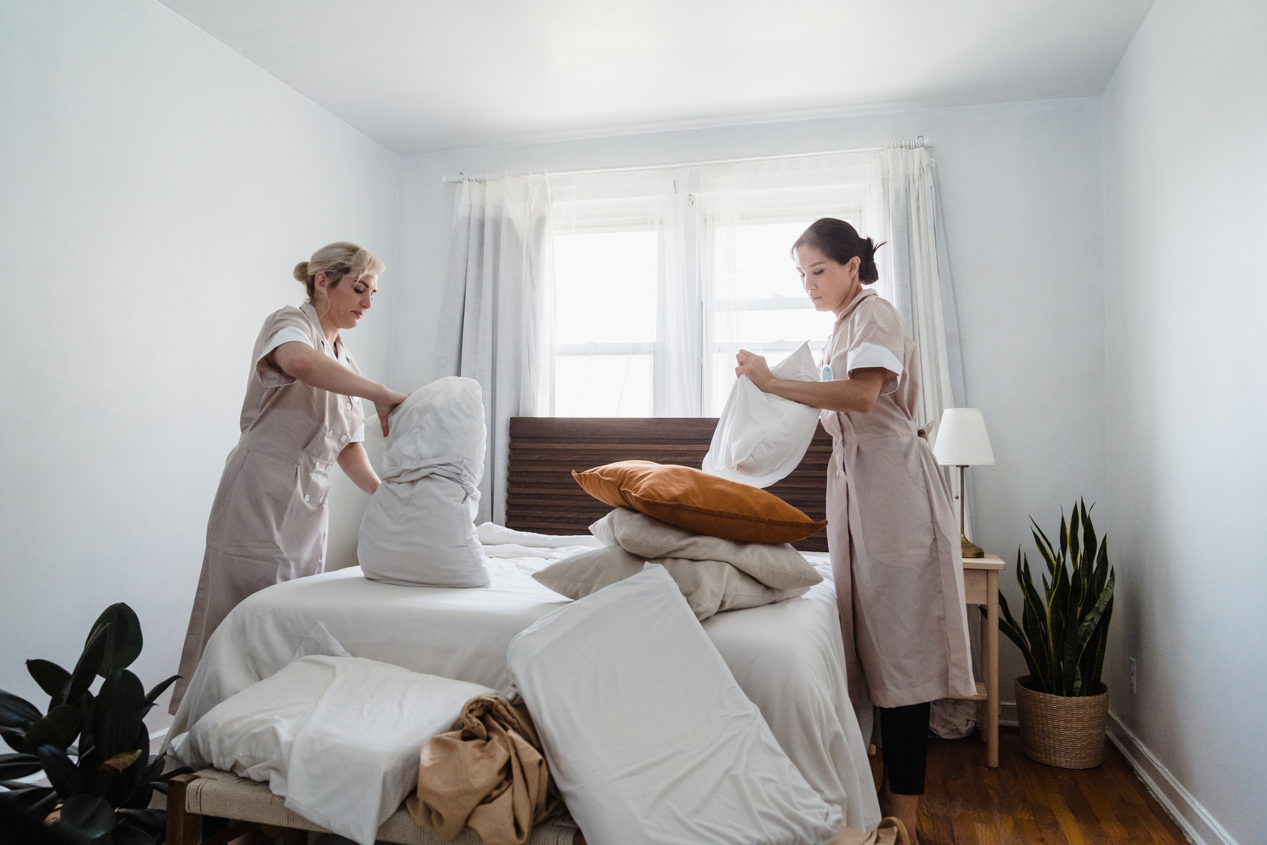 Housekeepers Tidying up a Bedroom